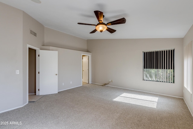 unfurnished bedroom featuring ceiling fan, vaulted ceiling, and light colored carpet