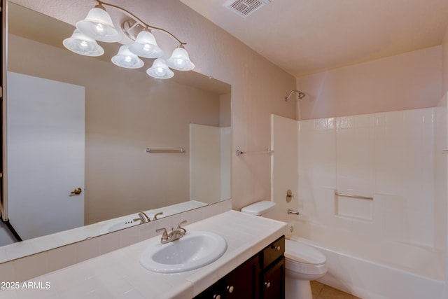 full bathroom with vanity, washtub / shower combination, and toilet