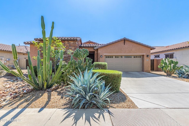 mediterranean / spanish home featuring fence, driveway, stucco siding, a garage, and a tile roof