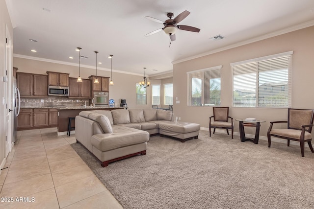 living room with light tile patterned floors, baseboards, visible vents, and ornamental molding