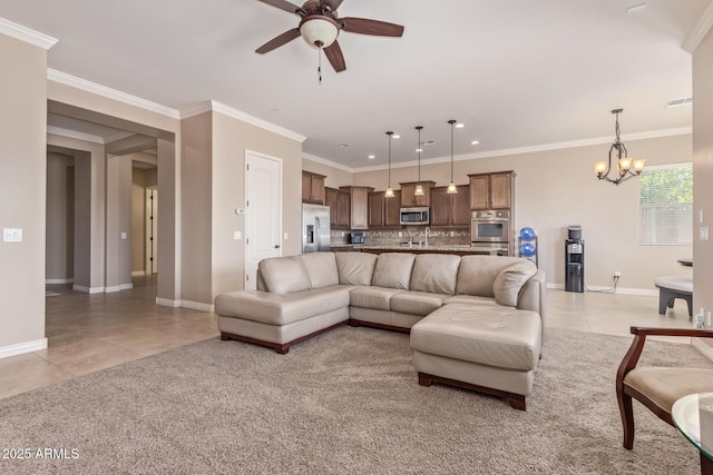 living room featuring light tile patterned flooring, ceiling fan with notable chandelier, baseboards, and ornamental molding