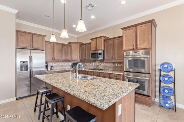 kitchen with visible vents, decorative backsplash, light tile patterned flooring, stainless steel appliances, and a sink