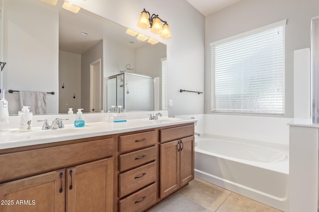 bathroom featuring a garden tub, a stall shower, a sink, tile patterned flooring, and double vanity