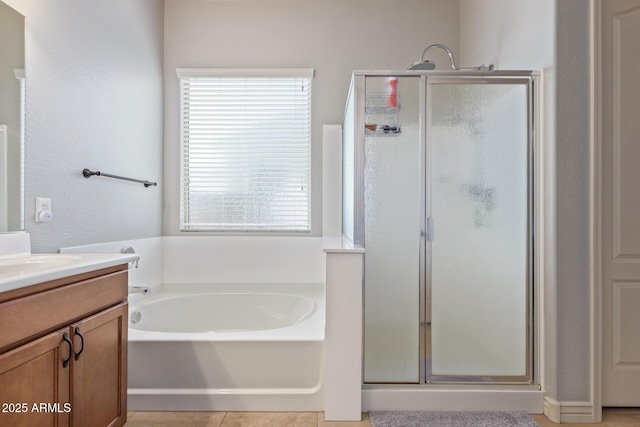 bathroom with tile patterned flooring, a shower stall, vanity, and a garden tub