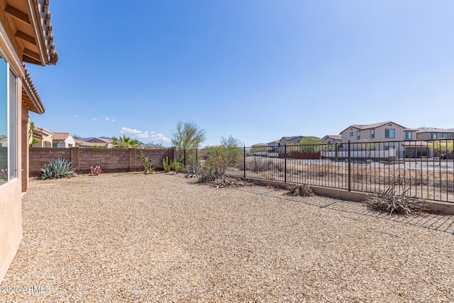 view of yard featuring a residential view and a fenced backyard