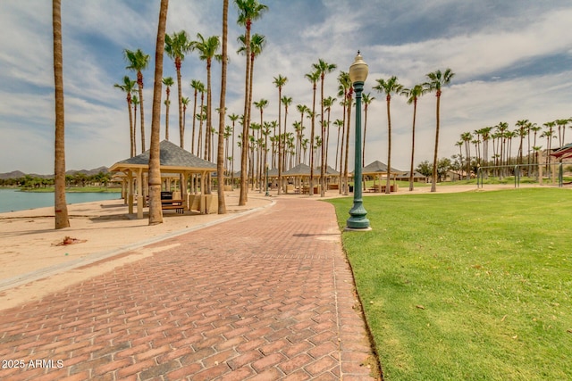 view of community with a gazebo, a yard, and a water view