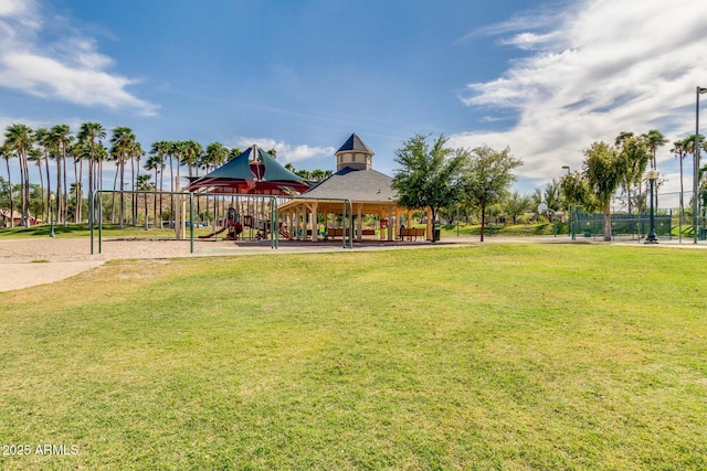 surrounding community featuring a lawn, playground community, and fence