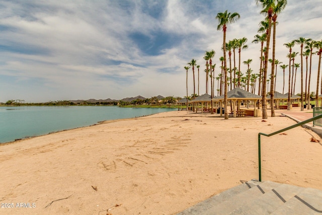 property view of water featuring a gazebo and a beach view