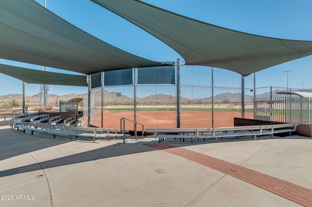 view of home's community featuring a mountain view and fence