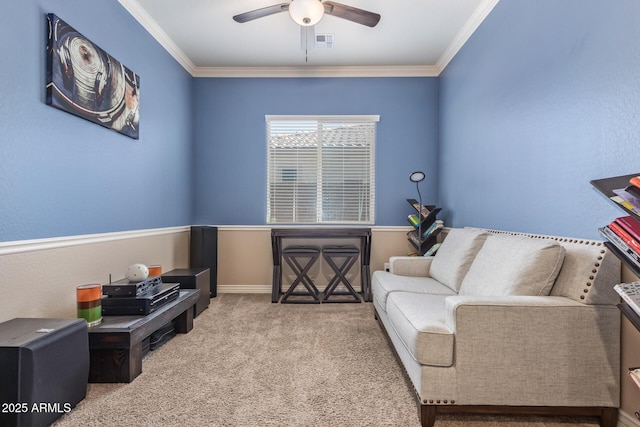 living area featuring visible vents, baseboards, carpet, ornamental molding, and a ceiling fan