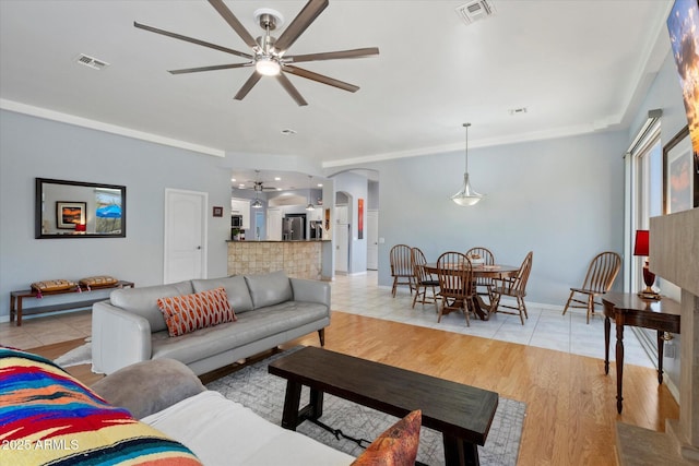 34611 N Sunset Trl, Cave Creek, AZ 85331 - living room featuring a ceiling fan, arched walkways, light tile patterned floors, and baseboards