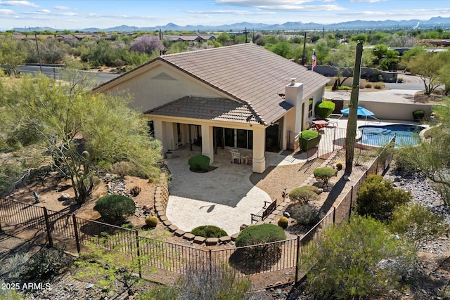 34611 N Sunset Trl, Cave Creek, AZ 85331 - rear view of house with a patio area, a tiled roof, stucco siding, a mountain view, and a fenced backyard