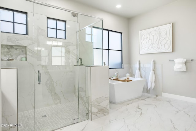 bathroom featuring separate shower and tub