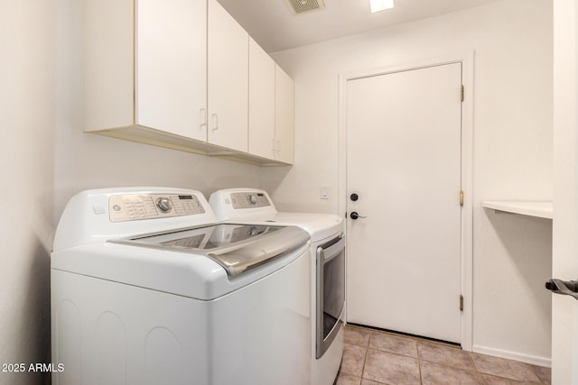 13599 W Monte Vista Rd, Goodyear, AZ 85395 - washroom featuring washer and dryer, cabinet space, and light tile patterned floors
