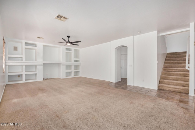 13599 W Monte Vista Rd, Goodyear, AZ 85395 - unfurnished living room featuring ceiling fan, arched walkways, carpet flooring, and stairway