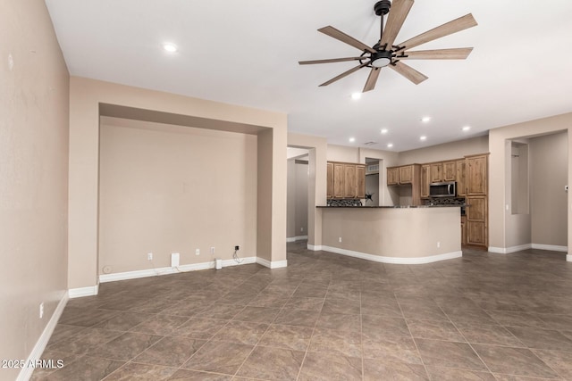 6805 S Sapphire Way, Chandler, AZ 85249 - kitchen with stainless steel microwave, a ceiling fan, dark countertops, open floor plan, and recessed lighting