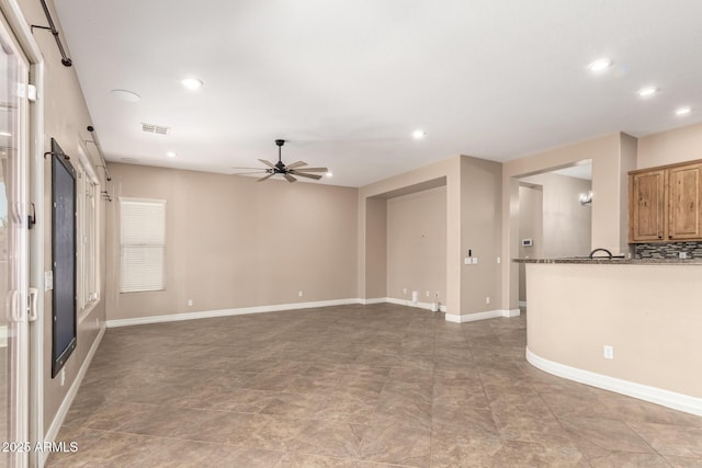 6805 S Sapphire Way, Chandler, AZ 85249 - unfurnished living room featuring ceiling fan, recessed lighting, and baseboards