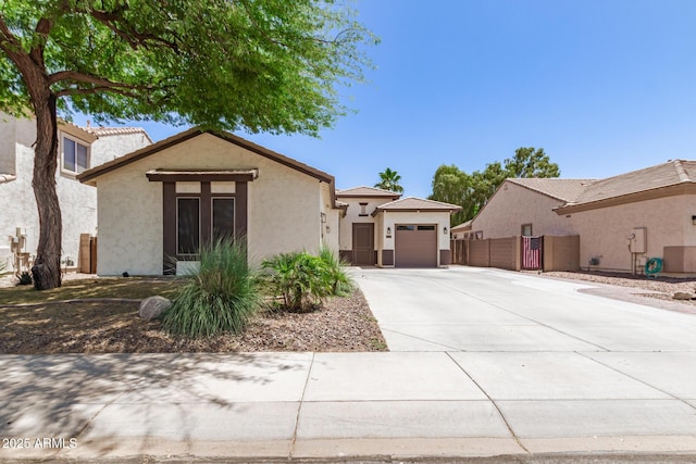6805 S Sapphire Way, Chandler, AZ 85249 - view of front of house featuring concrete driveway, stucco siding, a garage, and fence