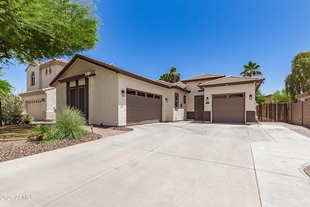 6805 S Sapphire Way, Chandler, AZ 85249 - view of front facade with an attached garage, stucco siding, driveway, and fence