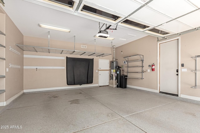 6805 S Sapphire Way, Chandler, AZ 85249 - garage with a garage door opener, gas water heater, and baseboards
