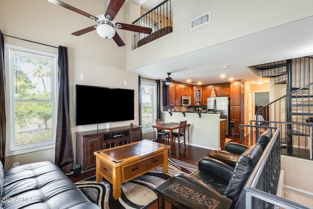 5734 S 21st Pl, Phoenix, AZ 85040 - living area featuring ceiling fan, plenty of natural light, wood finished floors, and stairway