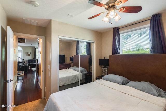 5734 S 21st Pl, Phoenix, AZ 85040 - bedroom featuring multiple windows, a closet, wood finished floors, and a ceiling fan