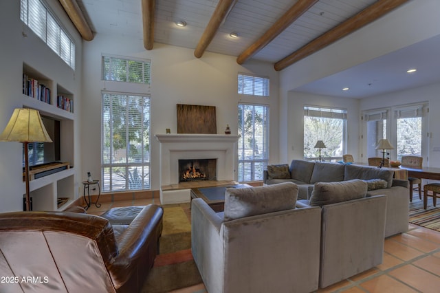 tiled living room featuring beam ceiling and built in features