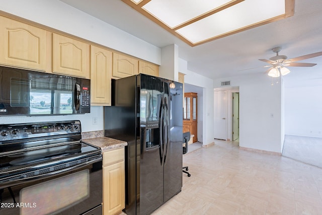 kitchen with visible vents, black appliances, light brown cabinetry, baseboards, and ceiling fan