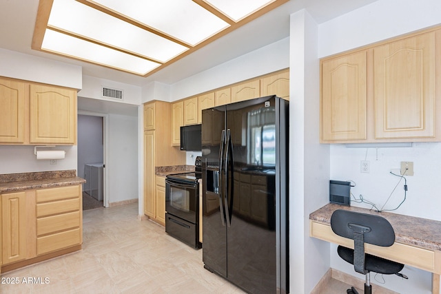 kitchen with visible vents, black appliances, light brown cabinetry, built in desk, and baseboards