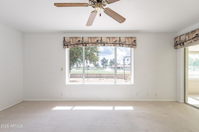 empty room with ceiling fan, baseboards, and carpet floors