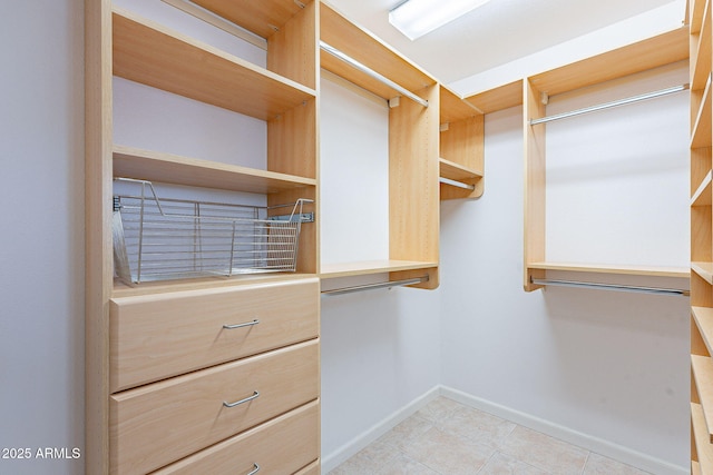 spacious closet featuring light tile patterned flooring