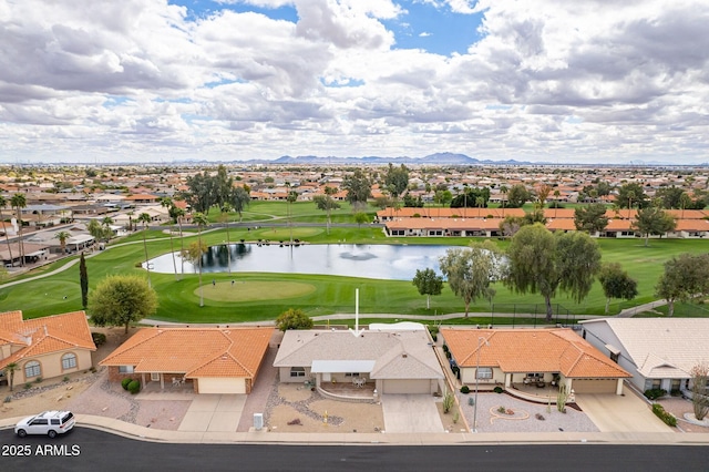 aerial view with golf course view, a residential view, and a water and mountain view