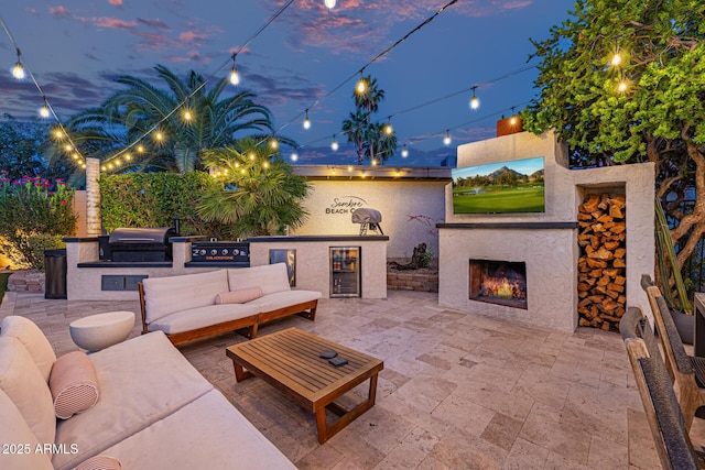7821 N Via De La Sombre, Scottsdale, AZ 85258 - view of patio / terrace with a grill, an outdoor kitchen, an outdoor living space with a fireplace, and beverage cooler