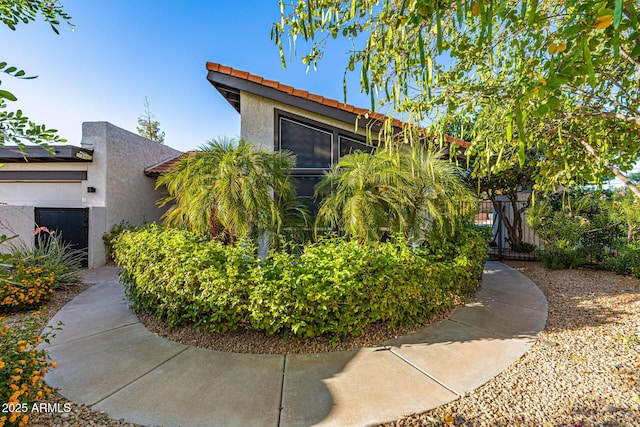 7821 N Via De La Sombre, Scottsdale, AZ 85258 - view of property exterior featuring stucco siding, fence, and a tiled roof