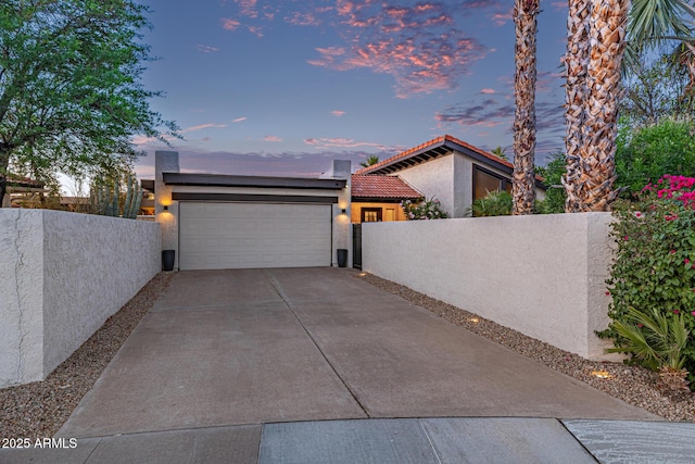 7821 N Via De La Sombre, Scottsdale, AZ 85258 - view of side of property with stucco siding, a garage, fence, driveway, and a tiled roof