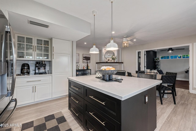 7821 N Via De La Sombre, Scottsdale, AZ 85258 - kitchen featuring dark cabinetry, freestanding refrigerator, white cabinets, light countertops, and recessed lighting