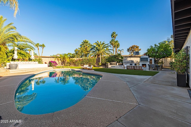 7821 N Via De La Sombre, Scottsdale, AZ 85258 - view of swimming pool with a lit fireplace, a patio area, and a fenced backyard