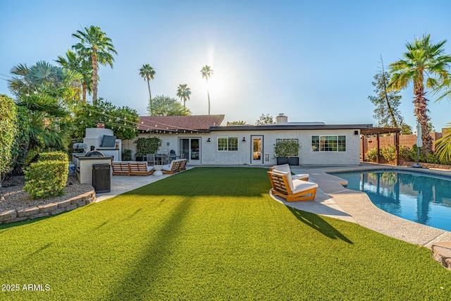 7821 N Via De La Sombre, Scottsdale, AZ 85258 - back of property with exterior kitchen, a patio, a lawn, and stucco siding