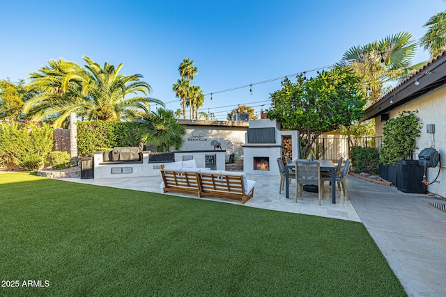7821 N Via De La Sombre, Scottsdale, AZ 85258 - view of yard with a patio, exterior kitchen, and an outdoor living space with a fireplace