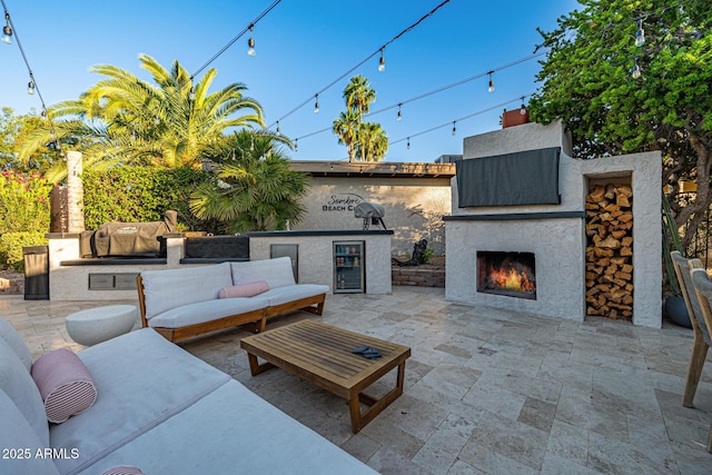 7821 N Via De La Sombre, Scottsdale, AZ 85258 - view of patio featuring grilling area, exterior kitchen, and an outdoor living space with a fireplace