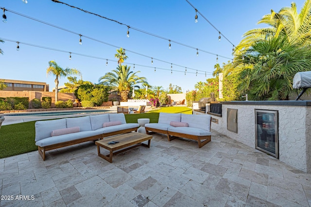 7821 N Via De La Sombre, Scottsdale, AZ 85258 - view of patio featuring an outdoor living space, a fenced backyard, and an outdoor kitchen