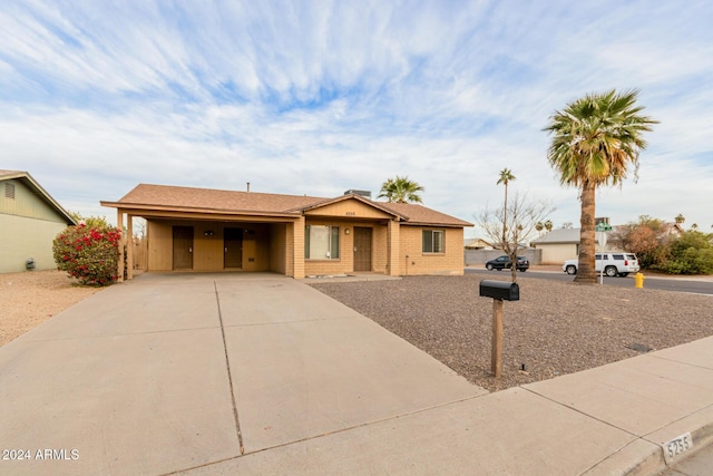 ranch-style house featuring a carport