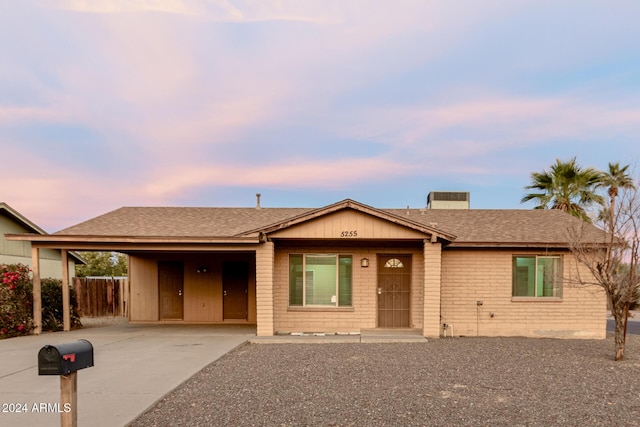 ranch-style home featuring a carport