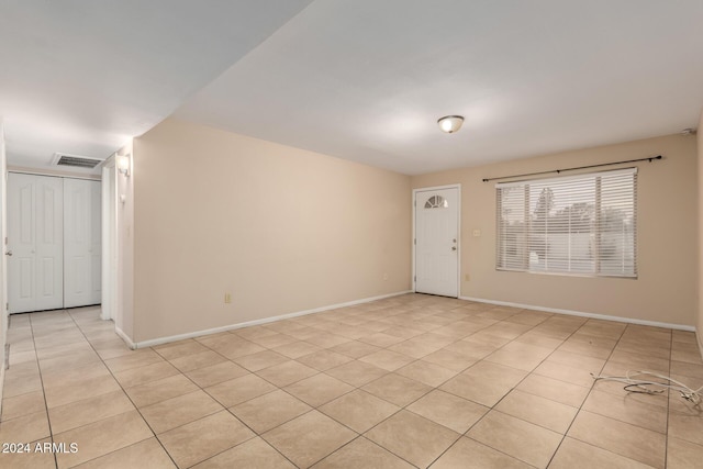 spare room with light tile patterned floors