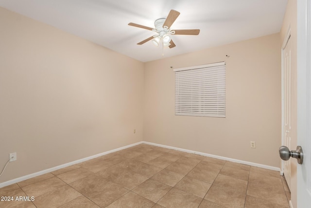 tiled empty room with ceiling fan