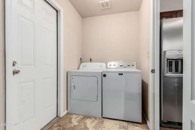 clothes washing area featuring washer and clothes dryer