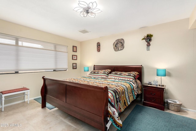 bedroom featuring baseboards and visible vents