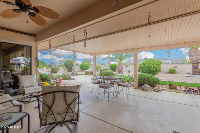 view of patio / terrace featuring ceiling fan, fence, and outdoor dining space