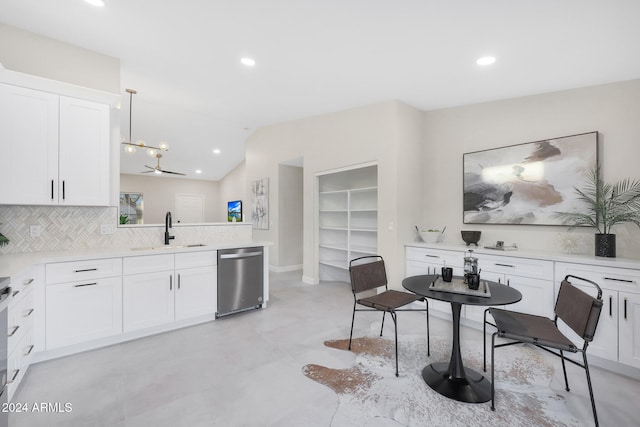 kitchen featuring sink, stainless steel appliances, pendant lighting, decorative backsplash, and white cabinets