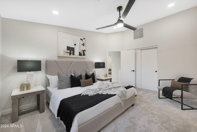 carpeted bedroom featuring a closet and ceiling fan